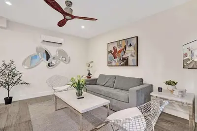 a living room with a couch and a ceiling fan at 2102 Eden Collection 1BR Kitchen Steps to beach in Fort Lauderdale