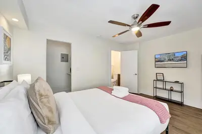a bedroom with a white bed and a ceiling fan at Eden Escape Walk to FLT Beach 1103 in Fort Lauderdale