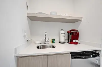 a kitchen counter with a sink and a microwave at Eden Escape Walk to FLT Beach 1102 in Fort Lauderdale