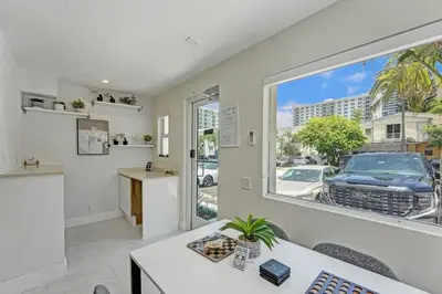 a living room with a white couch and a window at Eden Escape Walk to FLT Beach 1201 in Fort Lauderdale