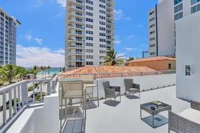 a balcony with chairs and a view of the ocean at Eden Escape Walk to FLT Beach 2107 in Fort Lauderdale