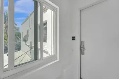 a white door with a window in a building at Eden Escape Walk to FLT Beach 2204 in Fort Lauderdale