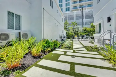 a garden with plants and stairs in a building at Eden Escape Walk to FLT Beach 2101 in Fort Lauderdale