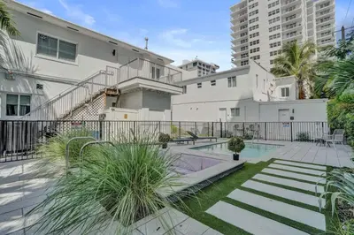 a building with a swimming pool in a courtyard at Eden Escape Walk to FLT Beach 2101 in Fort Lauderdale