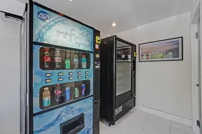 a vending machine with bottles of water in a room at Eden Escape Walk to FLT Beach 1206 in Fort Lauderdale