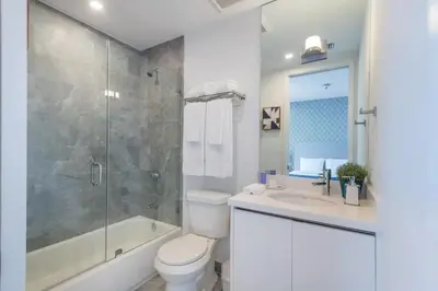 a bathroom with a toilet and a shower and a sink at 2BR South Beach | Moderno & Aconchegante in Miami Beach