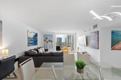a living room with a couch and a glass table at Stunning 3Bedroom 34th Floor Brickell Free Parking in Miami