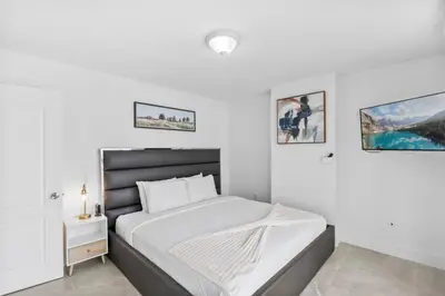 a bedroom with a large bed with white walls at Stunning 3Bedroom 34th Floor Brickell Free Parking in Miami