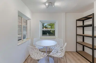 a dining room with a white table and chairs at Casa de Jai- your Green Space near Brickell in Miami