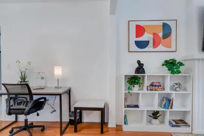 an office with a desk and a table and a chair at Casa de Jai- your Green Space near Brickell in Miami