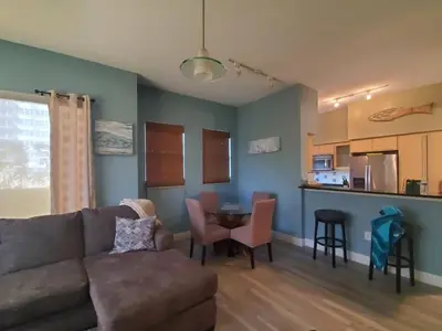 a living room with a couch and a table at Beautiful Mediterranean Oceanfront Condo with Private Beach in Hallandale Beach