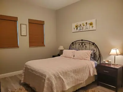 a bedroom with a bed and two lamps and a window at Beautiful Mediterranean Oceanfront Condo with Private Beach in Hallandale Beach