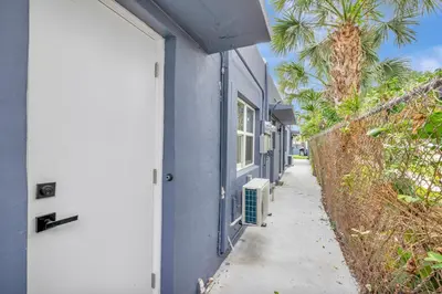 a blue house with a white door and a sidewalk at Banyan St 2BR 1BA off Las Olas Steps to Beach 1 in Fort Lauderdale