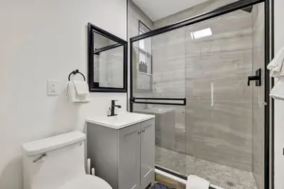 a bathroom with a shower and a toilet and a sink at Banyan St 2BR 1BA off Las Olas Steps to Beach 1 in Fort Lauderdale