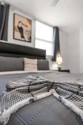 a blanket on a bed in a room with a window at Perfectly Located Miami 3BR with Stunning Views in Miami