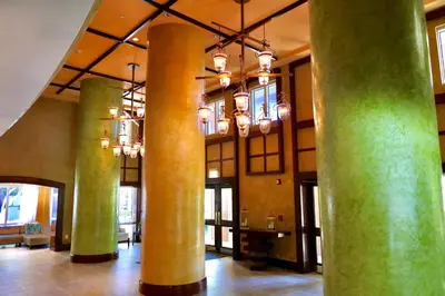 a lobby with columns and chandeliers in a building at Grove Cove - Pool Parking Central Coconut Grove in Miami