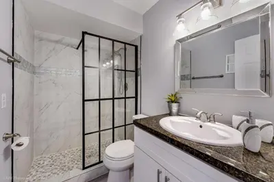 a white bathroom with a sink and a toilet at Spacious 4BR Miami Townhome with Communal Pool in Ives Estates