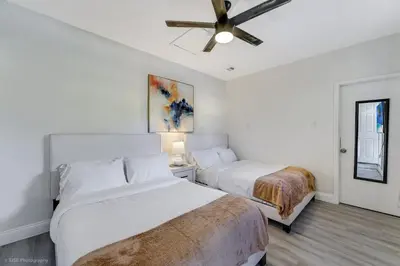 a bedroom with two beds and a ceiling fan at Spacious 4BR Miami Townhome with Communal Pool in Ives Estates