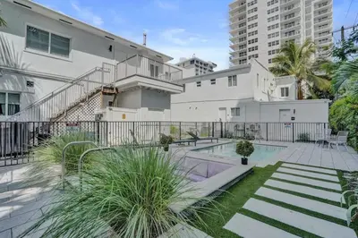 a building with a swimming pool in a courtyard at Eden Escape 1 BR 2202 Walk to FLT Beach in Fort Lauderdale