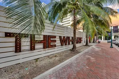 a wall with a sign that reads the west at Eden Escape Studio 2103 Walk to FLT Beach in Fort Lauderdale