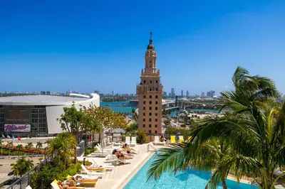 a view of a building with a pool and a clock tower at Extraordinary Studio in Downtown Miami with incredible views in Miami