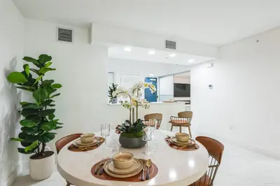 a white dining room with a table and chairs at Lux 2BR City-View Retreat in Hollywood, 2nd Floor in Hollywood