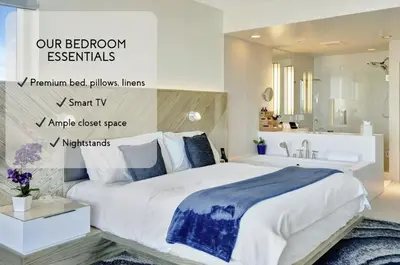 a bedroom with a large bed and a bathroom at Beach Club - Oceanfront Luxury, Resort Amenities, Balcony Views in Fort Lauderdale