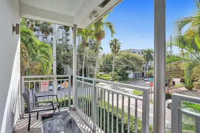 a balcony with a chair and a view of a street at Villa Monaco in Miami Beach