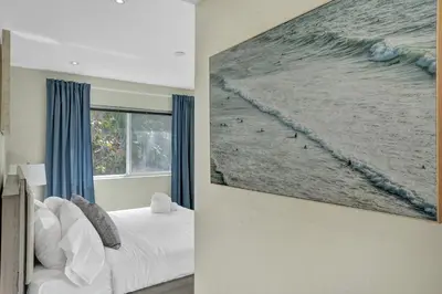 a bedroom with a large painting on the wall at Villa Monaco in Miami Beach