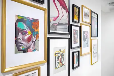 a group of framed art on a wall at Tropical Guest House at VIlla Verde Miami in Miami