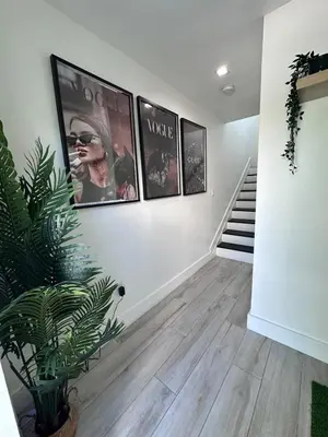 a living room with three pictures on the wall at Tropical Guest House at VIlla Verde Miami in Miami