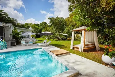 a backyard with a swimming pool with a gazebo at Miami Pool Cottage in Miami