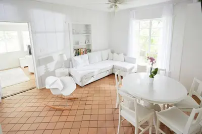 a living room with a white couch and a table at Miami Pool Cottage in Miami