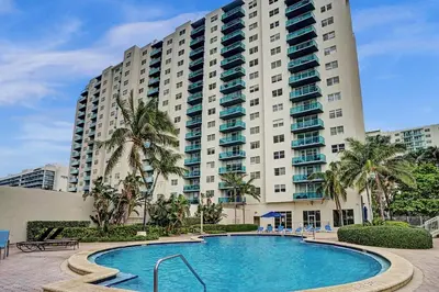 a large building with a swimming pool in front of a building at Luxury Oceanfront 2 Bedroom ON THE BEACH 3 FLOOR in Hollywood