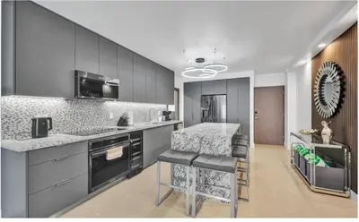 a kitchen with gray cabinets and a counter top at Luxury Oceanfront 2 Bedroom ON THE BEACH 3 FLOOR in Hollywood