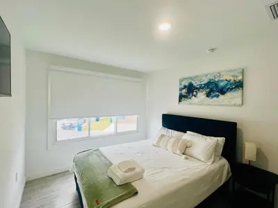 a bedroom with a large white bed with a window at 3BR Townhouse, Miami and the Keys in Homestead