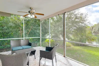 a screened in porch with a table and chairs at 8 Mi to Wynwood Waterfront Retreat with Lanai in Miami