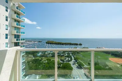 a view of the ocean from the balcony of a building at 2 bedroom Bay View Beauty in Coconut Grove- Parking for 2 cars included! in Miami