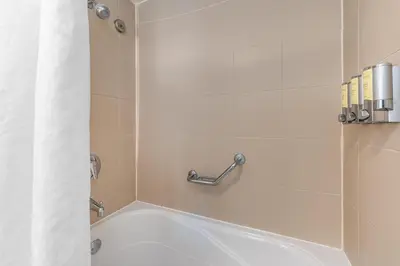a bath tub in a bathroom with a shower at Coconut Grove Bayview unit Parking Included in Miami