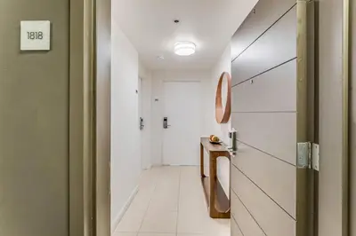 a hallway with a door leading into a room at Coconut Grove Bayview unit Parking Included in Miami