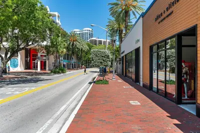 an empty street in a city with palm trees at Coconut Grove Bayview unit Parking Included in Miami