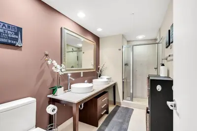 a bathroom with two sinks and a shower at Icon brickell The W hotel residence in Miami