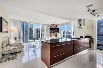 a kitchen with a large island in a living room at Icon brickell The W hotel residence in Miami