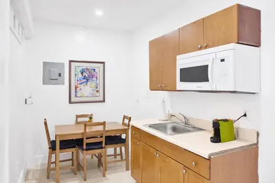 a kitchen with a sink and a table and a microwave at Miami Designer Apartment Unit 1 in Miami