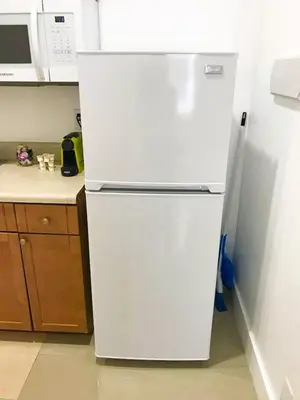 a white refrigerator in a kitchen next to a counter at Miami Designer Apartment Unit 1 in Miami
