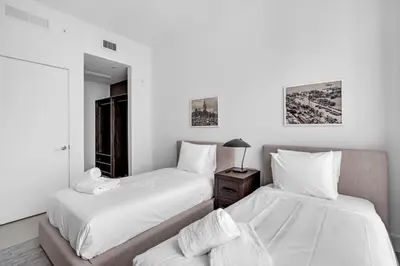 a bedroom with two beds and a night stand at Hotel 601 in Miami