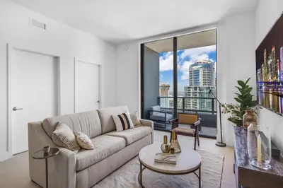 a living room with a couch and a large window at Hotel 601 in Miami