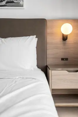 a bedroom with a bed and a night stand with a lamp at Hotel 601 in Miami