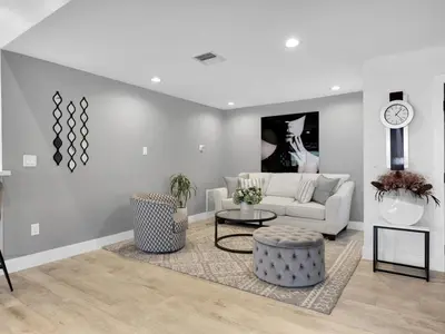 a living room with a white couch and a table at Tropical Dream House in Plantation 3 Bedroom Home with Pool in Plantation