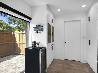 a kitchen with white walls and a sliding door at Tropical Dream House in Plantation 3 Bedroom Home with Pool in Plantation
